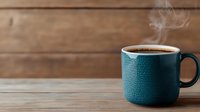 Steaming hot coffee in teal ceramic mug on rustic wooden table background, morning beverage with rising steam against warm brown planks.