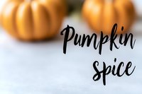 Decorative orange pumpkins with elegant "Pumpkin Spice" calligraphy text overlay on soft white background, perfect for autumn seasonal marketing.