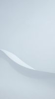 Minimalist white curved surface with soft shadows on light gray background for modern design and product presentation.