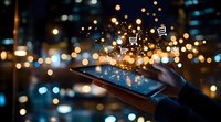 Online shopping on smartphone with glowing cart icons and magical sparkles floating above screen against blurred city lights at night creating magical atmosphere.