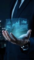 Businessman holding holographic financial data displays with glowing charts, graphs and analytics for business intelligence, investment analysis and digital technology concepts.