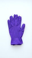 Single purple latex glove isolated on white background, suitable for medical, healthcare, safety, and hygiene-related design projects and presentations.