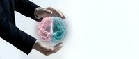 Male hands in dark business suit holding glowing brain hologram with pink and blue hemispheres, representing artificial intelligence, innovation, and technology solutions.