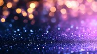 Magical glitter bokeh background with purple and orange defocused lights creating dreamy atmosphere for festive designs and holiday decorations.