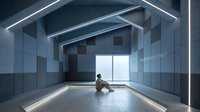 Young Asian man sitting alone in modern minimalist interior with geometric ceiling beams and large window providing natural light for contemplation.