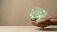 Hands holding glowing green eco-friendly icons representing sustainable business practices and environmental responsibility for corporate presentations.