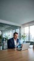 Professional businessman using holographic technology interface at modern office desk with laptop for digital transformation and innovation concepts.