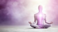 Silhouette in lotus position with glowing purple, spiritual energy concept for wellness and mindfulness practice.