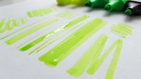 Bright green adhesive tape strips arranged on white surface, ready for craft projects, packaging, and design applications.