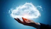 Business professional hand presenting glowing cloud computing technology with network connections on blue background for digital transformation concepts.