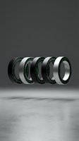 Four futuristic smart rings with green digital code details float in a studio, showcasing sleek black and silver wearable tech design.