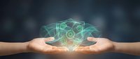 Digital network connections floating above cupped hands with glowing green data links and nodes representing cloud computing and connectivity solutions.