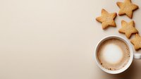 Creamy cappuccino in white cup with star shaped butter cookies on beige background. Minimalist coffee break composition with copy space for menu or cafe.