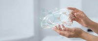 Hands protecting digital brain with network connections representing artificial intelligence, machine learning and neural technology innovation.