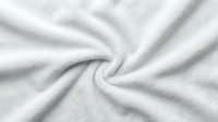 Soft white fabric texture with gentle folds and wrinkles, suitable for backgrounds, textile design, and product mockups.