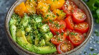 Fresh poke bowl with sliced avocado, cherry tomatoes, mango chunks garnished with sesame seeds and herbs in ceramic bowl on dark background.