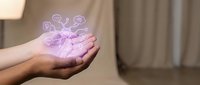 Hand holding glowing purple virus particles with DNA strands floating above palm in soft indoor lighting for medical education and healthcare concepts.