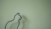 Minimalist black line drawing of cat silhouette on sage green background for modern home decor and wall art applications.