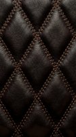 Dark brown quilted leather texture with diamond pattern stitching for luxury upholstery and interior design backgrounds.