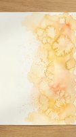 Abstract watercolor painting with warm yellow and orange tones creating organic flowing shapes on textured paper for artistic design projects.