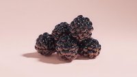 Fresh ripe blackberries cluster on soft pink background, organic summer fruit harvest for healthy eating and culinary recipes.
