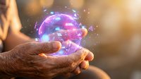 Hand holding glowing purple and blue energy sphere with magical particles, representing innovation, technology, power, and future concepts for business and creative projects.
