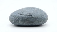 Smooth gray granite pebble stone isolated on white background for zen meditation, spa decoration, natural rock element for wellness and relaxation design.