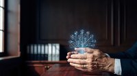 Mature male professional holding glowing digital circuit tree icon, representing artificial intelligence, technology innovation, and digital transformation in business environment.