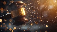 Wooden judge gavel on dark background with golden glowing sparkles and bokeh lights creating dramatic legal atmosphere. Suitable for law firm marketing.