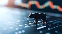 Bear figurine on financial chart with downward trend representing bearish stock market sentiment and declining investment performance in low light conditions.
