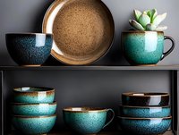 Handcrafted ceramic dinnerware collection with turquoise and brown glazed bowls, plates and mugs displayed on modern kitchen shelves with succulent plant.