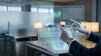 Hands in gloves interact with holographic data visualization interface displaying financial charts and graphs in modern office environment for technology and business concepts.