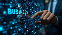 Businessman hand touching glowing business text on digital screen with data code and network connections for technology and corporate concepts.