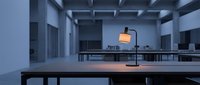 Empty modern office space with minimalist desks, overhead lighting, and clean architectural design. Suitable for corporate, business, and workspace concepts.