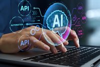 Businessman hands typing on laptop with glowing AI and API technology icons floating above keyboard for software development and automation solutions.