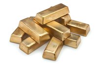 Stack of shiny gold bars arranged randomly on white background, showing wealth, luxury and financial investment concept. Isolated photo ready for design use.