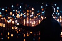 Silhouette of person reaching towards glowing bokeh lights at night, creating magical atmosphere with blurred city lights background and dreamy mood.