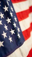 Close-up of American flag with white stars on blue field and red stripes, patriotic symbol for Independence Day, Memorial Day, and national celebrations.