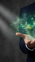 Businessman holding glowing green digital interface with sustainability icons including carbon reduction, renewable energy, and efficiency metrics for environmental business solutions.