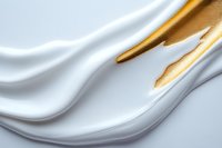 Elegant white and gold fluid waves create luxurious abstract background with smooth silky texture and flowing curves, suitable for cosmetic and luxury product designs.