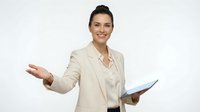 Professional businesswoman in beige suit presenting with tablet and welcoming gesture on white background isolated for corporate design use.