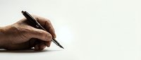 Male hand holding black pen writing on white paper with copy space for business documents and contracts.