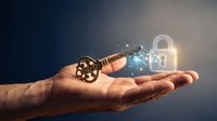 Hand holding glowing digital key unlocking padlock with light effects representing cybersecurity access control and data protection technology concepts.