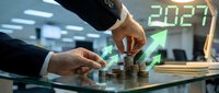 Business professional stacking coins with upward arrow and 2027 hologram in modern office environment representing financial growth and future investment planning.