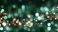 Magical glowing string lights and bokeh effects on dark green background create dreamy festive atmosphere for holiday designs and celebrations.