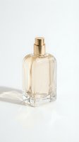 Elegant glass perfume bottle with golden cap containing light amber liquid, isolated on white background for cosmetics, fragrance, and beauty product design use.