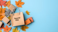 Shopping bag with special offer text surrounded by autumn maple leaves and gift boxes on blue background, seasonal sale concept for fall promotions.