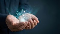 Businessman holding glowing digital brain with circuit patterns and light particles, representing artificial intelligence, technology innovation, and data processing for business solutions.
