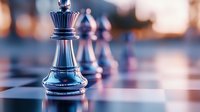 Black chess king piece standing on chessboard with blurred pawns in background, dramatic lighting creates strategic business leadership concept.