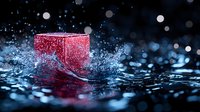 Red cube splashing into water creating dynamic ripples and droplets against dark background with bokeh lights, dramatic high-speed photography effect.